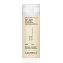 A clear bottle of Giovanni Cosmetics TEA TREE TRIPLE TREAT™ INVIGORATING SHAMPOO with a white cap. The label notes it’s salon-quality, color-safe, for all hair types, and free of sulfates and parabens. Available in 2 sizes.