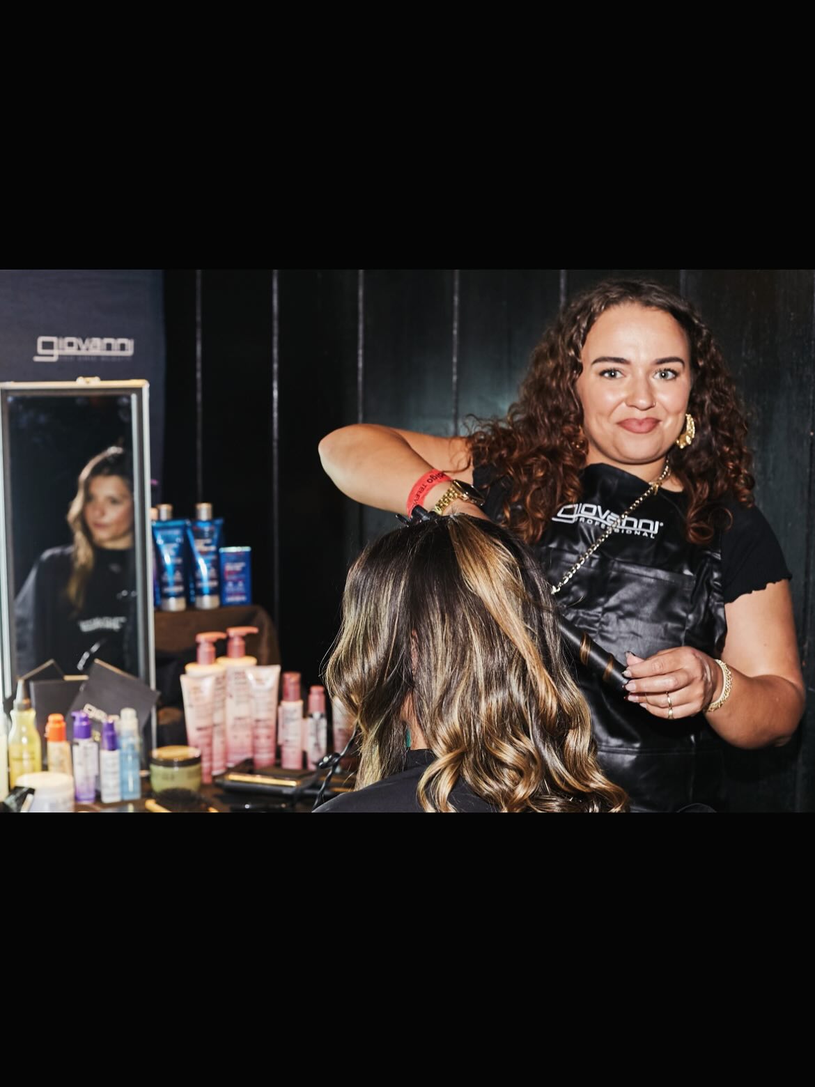 Woman getting her hair styled back stage at the National Television Awards