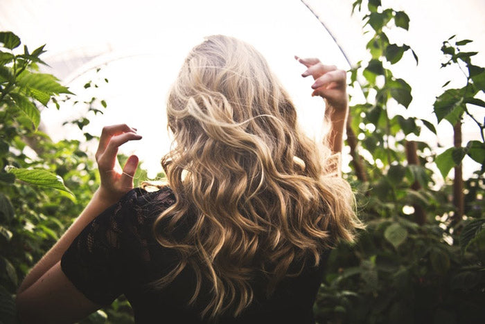 Blonde woman walking through nature 